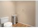Cozy bathroom featuring a pedestal sink, toilet, and wood-look flooring at 9898 Tourmaline Ct, Parker, CO 80134