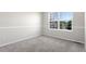 Empty bedroom featuring neutral walls and carpet with a large window at 9898 Tourmaline Ct, Parker, CO 80134