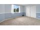 Bright bedroom with a large window, blue walls, and closet with sliding doors at 9898 Tourmaline Ct, Parker, CO 80134