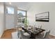 Bright dining room features large windows, hardwood floors, and a modern dining set at 9898 Tourmaline Ct, Parker, CO 80134