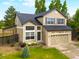 Charming two-story home featuring a spacious front yard, attached garage, and mature trees at 9898 Tourmaline Ct, Parker, CO 80134
