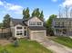 Charming two-story home featuring a two-car garage, landscaped yard, and mature trees at 9898 Tourmaline Ct, Parker, CO 80134