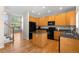 Spacious kitchen with stainless steel appliances, wood cabinets, granite countertops and hardwood flooring at 9898 Tourmaline Ct, Parker, CO 80134