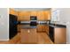 Functional kitchen with wood cabinets, granite countertops and center island at 9898 Tourmaline Ct, Parker, CO 80134