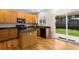 Functional kitchen with wood cabinets, dark countertops, and a central island with backyard access at 9898 Tourmaline Ct, Parker, CO 80134
