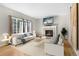 Bright living room with fireplace, large windows, and comfortable seating at 9898 Tourmaline Ct, Parker, CO 80134