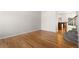 Open floor plan living room with hardwood floors and view into kitchen area at 9898 Tourmaline Ct, Parker, CO 80134
