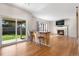 Inviting living area boasting hardwood floors, a stone fireplace, and sliding door access to the backyard at 9898 Tourmaline Ct, Parker, CO 80134