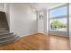 Bright living room with hardwood floors, large windows, and staircase at 9898 Tourmaline Ct, Parker, CO 80134