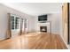Spacious living room with fireplace, hardwood floors, and large windows at 9898 Tourmaline Ct, Parker, CO 80134
