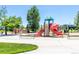Community playground with slides, climbing structures, and a soft landing surface at 9898 Tourmaline Ct, Parker, CO 80134