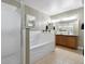 This light and bright bathroom features a shower, soaking tub, double sinks and granite counters at 1761 S Buchanan Cir, Aurora, CO 80018