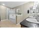 This well-lit bathroom offers double sinks with granite counters, a shower, and a soaking tub at 1761 S Buchanan Cir, Aurora, CO 80018