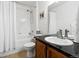 Bathroom featuring a shower-tub combo, a sink with vanity, and neutral decor at 1761 S Buchanan Cir, Aurora, CO 80018