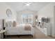 This sunny bedroom includes a ceiling fan, large window, and neutral decor at 1761 S Buchanan Cir, Aurora, CO 80018