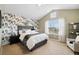Bright bedroom features a large window, wallpaper accent wall, and cozy decor at 1761 S Buchanan Cir, Aurora, CO 80018