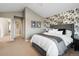 This spacious bedroom features attractive floral wallpaper, a comfortable bed, and neutral decor at 1761 S Buchanan Cir, Aurora, CO 80018