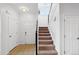 Bright entryway and staircase featuring carpeted steps and neutral decor at 1761 S Buchanan Cir, Aurora, CO 80018