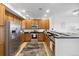 Modern kitchen featuring stainless appliances, dark countertops, and ample wood cabinetry at 1761 S Buchanan Cir, Aurora, CO 80018