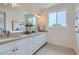 Modern bathroom featuring double sinks, a large mirror, and stylish light fixtures at 388 E Orchard Rd, Centennial, CO 80121