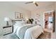Bright bedroom with a queen-size bed, ceiling fan, and access to home office at 388 E Orchard Rd, Centennial, CO 80121