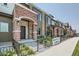 Brick townhouses with welcoming front porches and well-manicured landscaping at 388 E Orchard Rd, Centennial, CO 80121