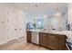 Open kitchen with island, stainless steel dishwasher, and light wood floors at 388 E Orchard Rd, Centennial, CO 80121