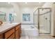 Bathroom features double sink vanity, a soaking tub, and a glass enclosed shower at 1024 Cottonwood Cir, Golden, CO 80401