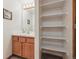 Bathroom with single sink vanity, built-in shelves, and neutral color palette at 1024 Cottonwood Cir, Golden, CO 80401