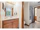 Bathroom with single sink vanity, shower-tub combo, and wood cabinetry at 1024 Cottonwood Cir, Golden, CO 80401