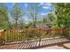 Outdoor deck with a wooden railing, ideal for enjoying views of the serene, tree-filled surroundings at 1024 Cottonwood Cir, Golden, CO 80401