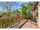 Wooden deck with a railing, perfect for enjoying views of the surrounding lush greenery and neighborhood at 1024 Cottonwood Cir, Golden, CO 80401