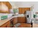 Eat-in kitchen showcases wood cabinets, stainless steel refrigerator and a view to the backyard at 1024 Cottonwood Cir, Golden, CO 80401