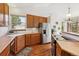 Sun-filled kitchen with wood cabinets, stainless steel appliances and outdoor views at 1024 Cottonwood Cir, Golden, CO 80401