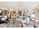 Bright living room features an open floor plan with a kitchen bar and vaulted ceilings at 1024 Cottonwood Cir, Golden, CO 80401