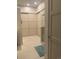 Bright bathroom featuring tile floor, glass shower, linen closet, and white paneled doors, creating a clean and organized space at 19 S 45Th Ave, Brighton, CO 80601