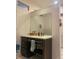 This bathroom features a dark wood vanity with light countertop, paired with modern fixtures and a rectangular mirror at 19 S 45Th Ave, Brighton, CO 80601