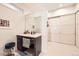 Modern bathroom featuring a vanity with dark cabinets, a large mirror, and tiled floors at 19 S 45Th Ave, Brighton, CO 80601