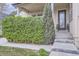 Inviting covered front porch with string lights and lush green shrubbery at 19 S 45Th Ave, Brighton, CO 80601