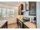 A modern kitchen featuring granite countertops, stainless steel appliances, and dark wood cabinetry at 19 S 45Th Ave, Brighton, CO 80601