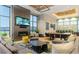 The spacious, well-lit living room features modern furnishings, a fireplace, and oversized windows at 19 S 45Th Ave, Brighton, CO 80601