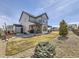 Lush backyard featuring a patio area, barbecue, dining table, and a well-manicured lawn at 8739 Culebra St, Arvada, CO 80007