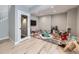 Basement play area with various toys, games, and a glass door at 8739 Culebra St, Arvada, CO 80007