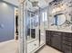 Stunning bathroom with a glass shower, modern vanity, and elegant floral wallpaper at 8739 Culebra St, Arvada, CO 80007