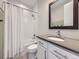 Bathroom featuring a shower-tub combination, white vanity and a large mirror at 8739 Culebra St, Arvada, CO 80007