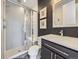 Modern bathroom featuring a walk-in shower, a dark accent wall and vanity at 8739 Culebra St, Arvada, CO 80007