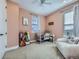 Bright bedroom featuring a crib, plush chair, and large window providing natural light at 8739 Culebra St, Arvada, CO 80007