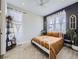 Bright bedroom featuring a white metal frame bed, dark accent wall and large windows providing natural light at 8739 Culebra St, Arvada, CO 80007