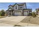 Impressive two-story home showcases attractive siding, a three-car garage, and a welcoming driveway at 8739 Culebra St, Arvada, CO 80007