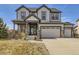 Charming two-story home showcasing stylish gray siding, stone accents, and a welcoming front porch at 8739 Culebra St, Arvada, CO 80007